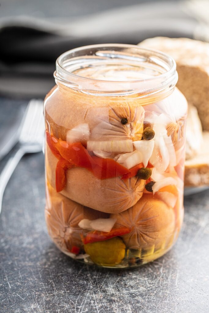 Pickled sausages with onion and red pepper.