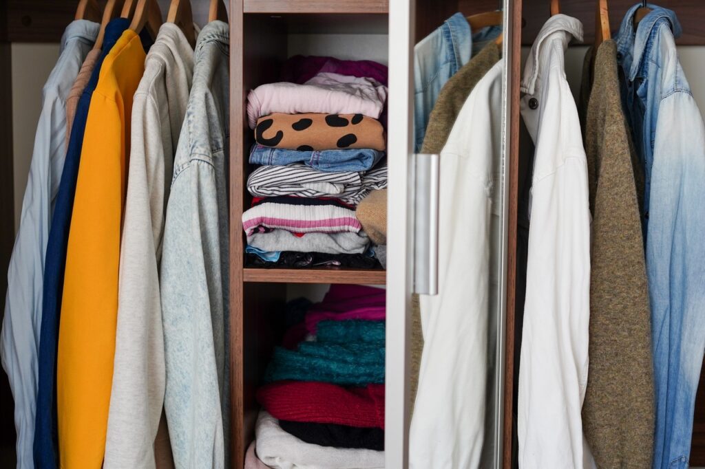 Wardrobe closet with different stylish clothes, home
